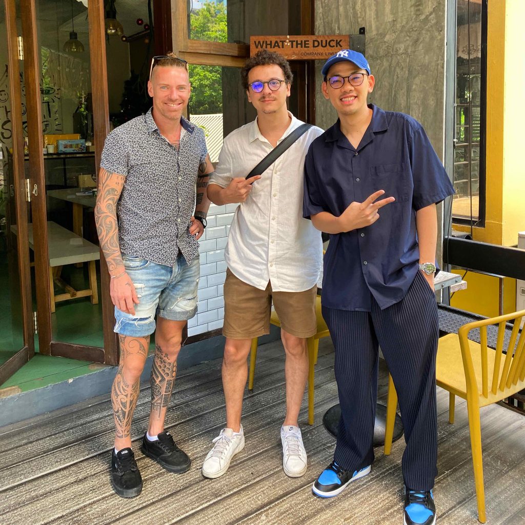 three man standing in front of music label
